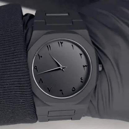 All-black watch with Arabic numerals on wrist, metal band - Souq Sama UAE
